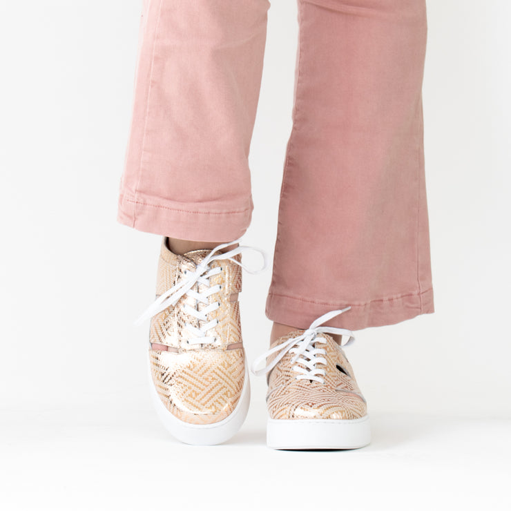 Minx Whisper Gold Metallic Sneakers side. Size 42 womens shoes. On Model with Long feet.