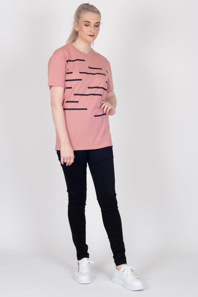 Tall model wearing Crossing The Lines Tee Rose, front 2