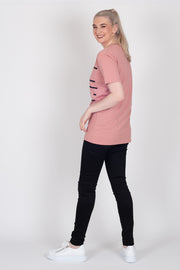 Tall model wearing Crossing The Lines Tee Rose, side