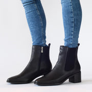 Woman modelling Hush Puppies Sublime Black Pebble Ankle boots. Boots for big size 13 feet