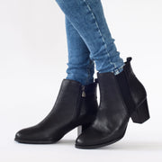 Model wearing Hush Puppies Shade Black size 11 Ankle boots