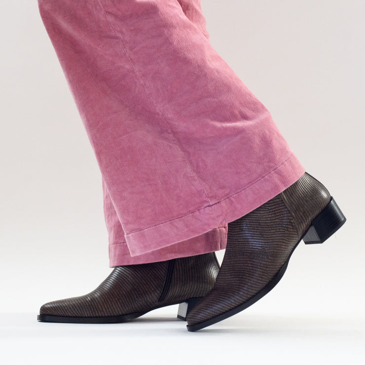 Model in Santi boots by Spanish brand Dansi in Taupe Lizard Print. Womens boots in size 42, 43, 44, 45