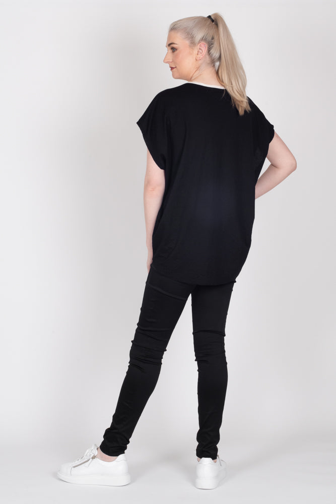 Tall model wearing Crossing The Lines Top Black, back