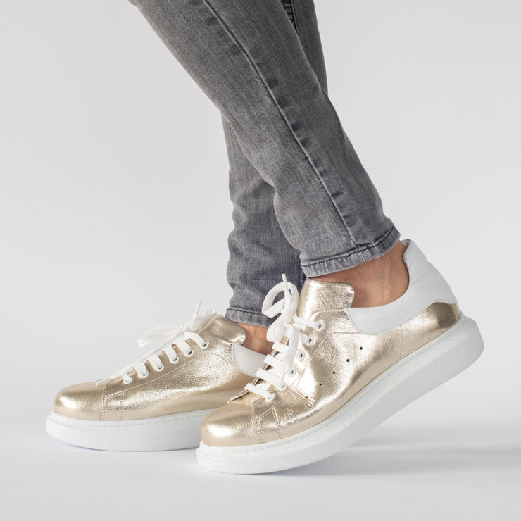 Model wearing Babouche Lifestyle Arrow 2 Gold. Size 12 women's Sneakers