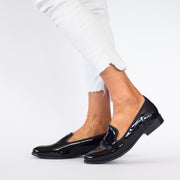 Model wearing Hush Puppies The Albert Black Patent shoes