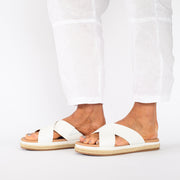 Model wearing Kelani White slides. Size 10 sandals
