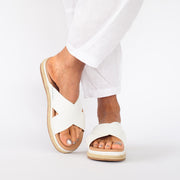 Model wearing Kelani White slides. Size 13 sandals