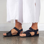 Model wearing Hush Puppies Nizki Black Leather sandals. Size 10 womens sandals