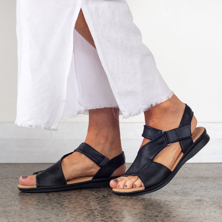 Model wearing Hush Puppies Nizki Black Leather sandals. Size 11 womens sandals