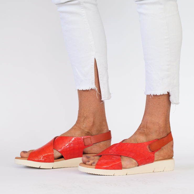 Model wearing Rosa Orange Patent Croc Print sandals by XBonita