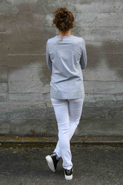 Back view of tall model wearing Penny Tee in Grey Marle with Aspen Y jeans in White