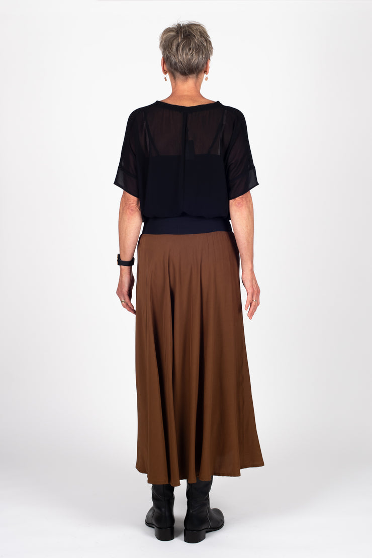 Tall model wearing Paris Skirt Cinnamon with top tucked in