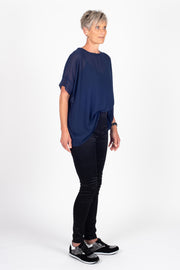 Tall model wearing Breezy Top Sapphire, side tucked in