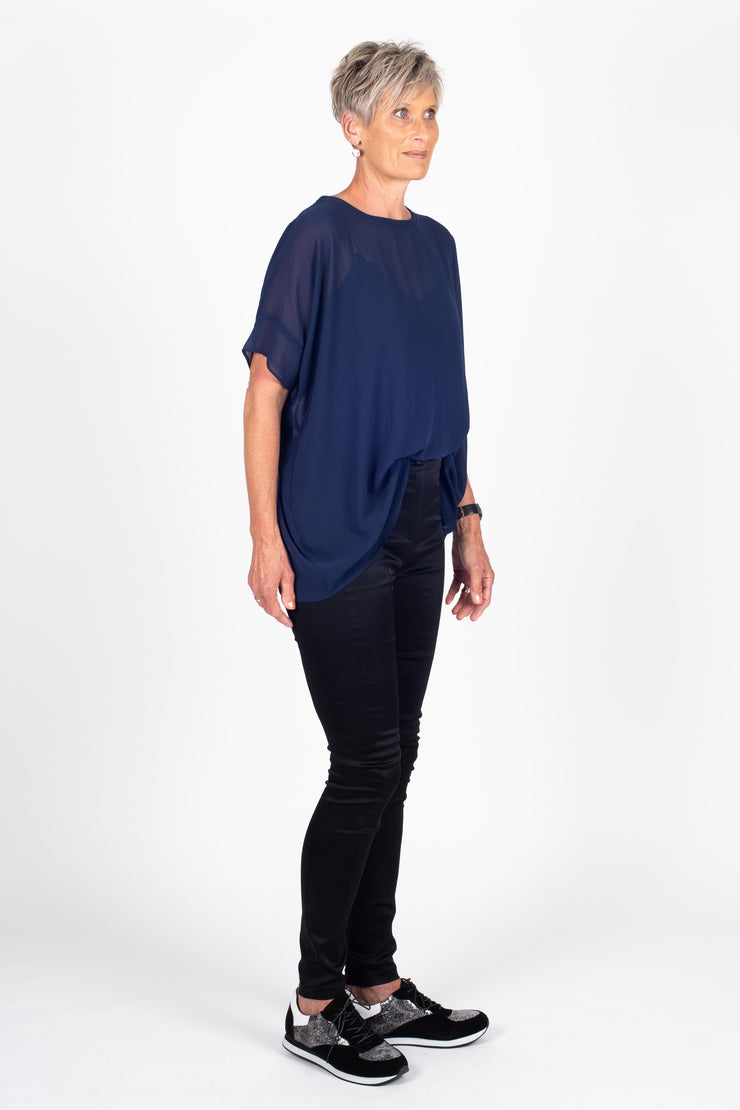 Tall model wearing Breezy Top Sapphire, side tucked in