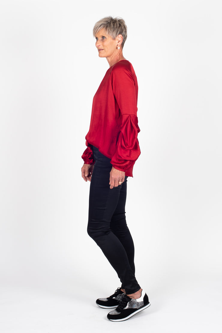 Tall model is wearing Tiered Shirt Red side