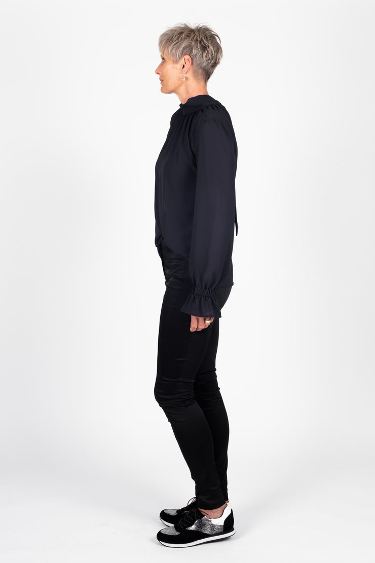 Tall model wearing Millie REVERSIBLE Top Black, side