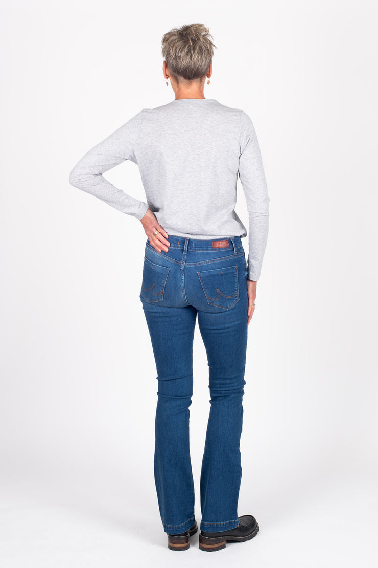 Tall model wearing Fallon Jeans Blue Wash, back