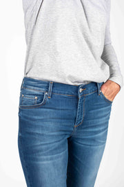 Tall model wearing Penny Tee Grey Marle, front tucked in