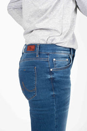 Tall model wearing Fallon Jeans Blue Wash, side close up