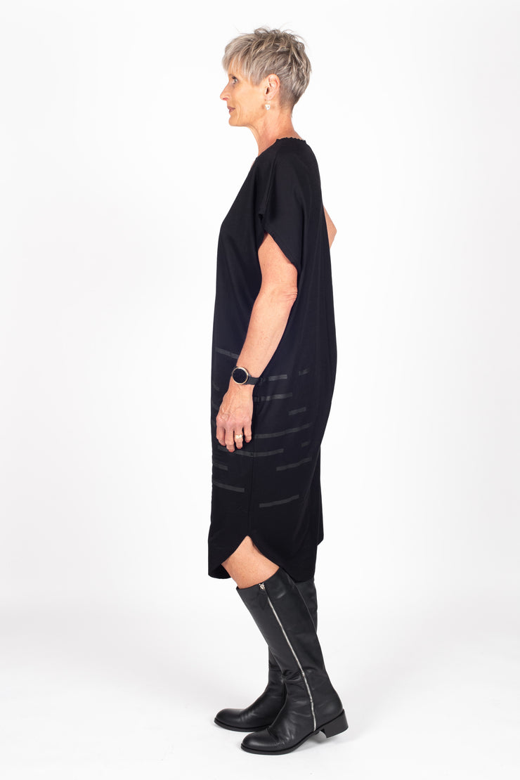Tall model wearing Crossing The Lines Dress Black Black, side