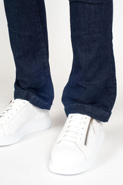 Tall model wearing Fallon Jeans Blue, front leg detail