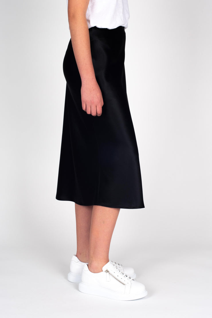 Model wearing Liquid Skirt Black Satin, side