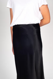 Model wearing Liquid Skirt Black Satin, front