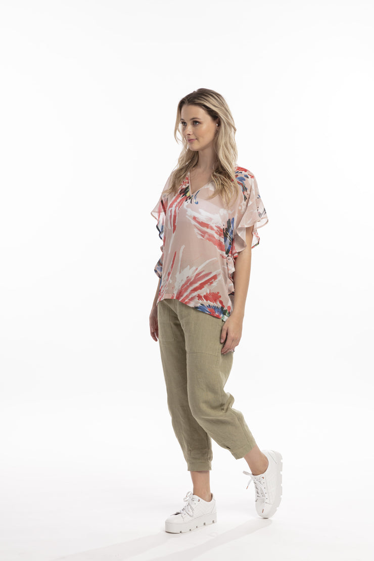 Model in Style X Lab Fly Away Top in Red Print. Made longer for tall women