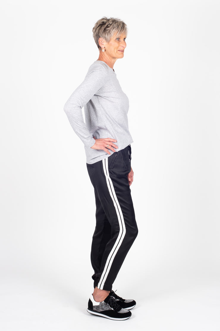 Tall model wearing Side Swipe Relax Pant Black Stripe, side